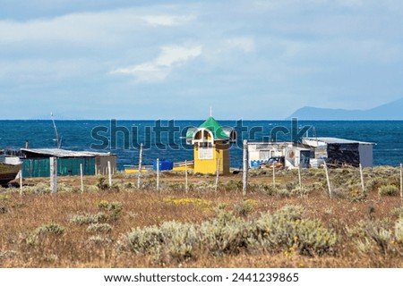 Patagonia landscape. Lonely house and boats in Patagonia Argentina, South America. Small village at Tierra del Fuego