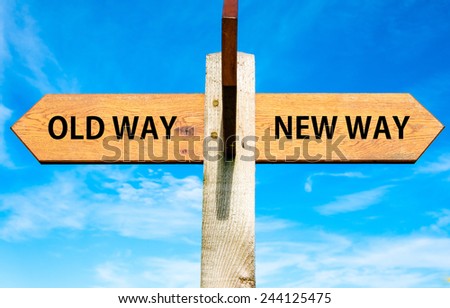 Wooden signpost with two opposite arrows over clear blue sky, Old Way and New Way signs