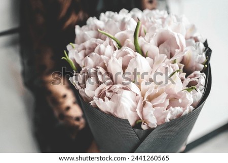 Girl with a bouquet of pink tulips close-up.