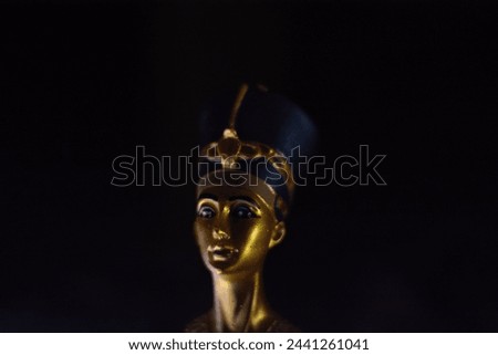 a beautiful small bust figurine of Queen Nefertiti Royalty-Free Stock Photo #2441261041