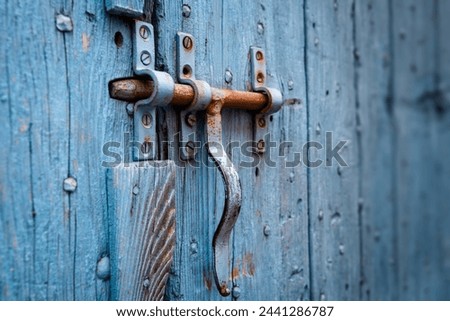 A doorknob and a lock on a blue door in South East France, but there are many villages and old houses with blue colored doors and windows.