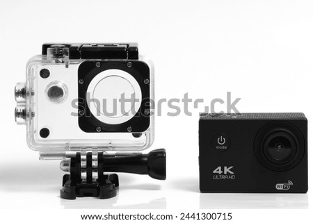 4K action camera on a white background and waterproof case Royalty-Free Stock Photo #2441300715