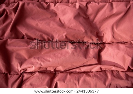 Texture fabric. Textile brown knitted cloth background. Jacket or coat for winter weather.