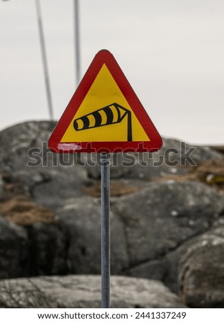 Road sign warning for strong winds.