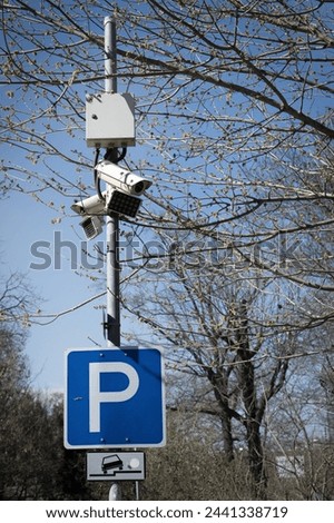 parking sign and security cameras in a park