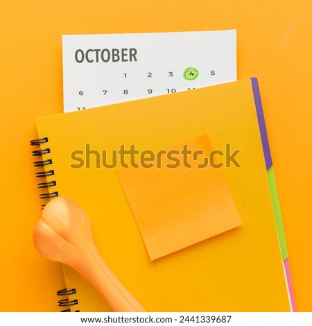 Top view of notebook with bone and calendar for animal day