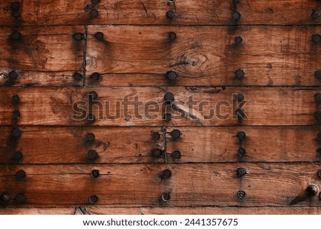 Construction of a wooden ship. Shipyard of traditional Dhow wooden boat on Iranian Qeshm Island. Board of Tradition Lenz Fishing Boat in Southern Iran. Old wooden stealth smuggler's ship. Royalty-Free Stock Photo #2441357675