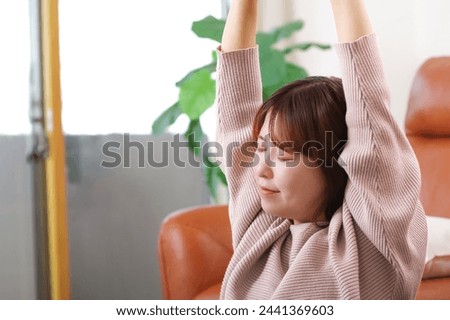 A woman stretching in the living room