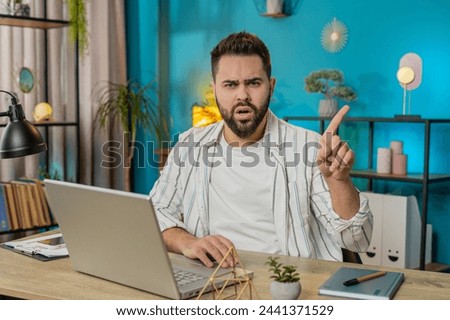 Displeased upset Caucasian man reacting to unpleasant awful idea, dissatisfied with bad quality, wave hand, shake finger No, dismiss idea don't like proposal. Young guy at home office table. Lifestyle Royalty-Free Stock Photo #2441371529