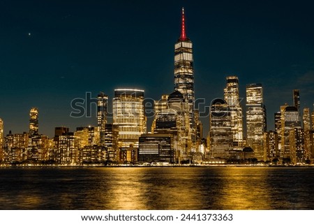 Manhattan skyline at night. New York city. Skyscraper building of NYC. NY urban city architecture. Night Manhattan and Hudson river. Metropolitan city. Metropolis cityscape. New York downtown