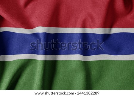 National Flag on Textured Fabric Background. Silk textured flag, realistic wave and flag look. GM  Flag of The Gambia