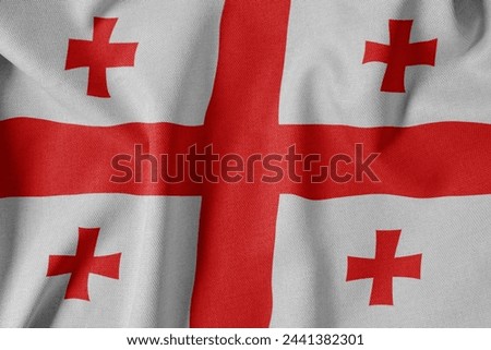 National Flag on Textured Fabric Background. Silk textured flag, realistic wave and flag look. GE  Flag of Georgia