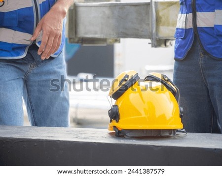 Yellow orange color hardhat helmet safety industry work equipment engineer construction protection job tool builder headwear occupation labor day nation american south african september event banner  Royalty-Free Stock Photo #2441387579