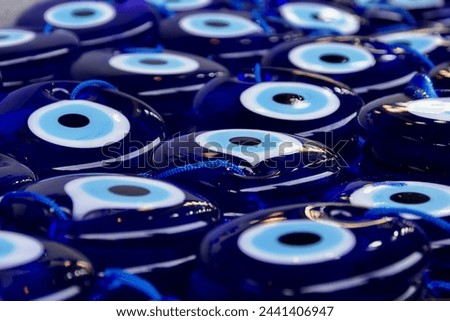 Background of many traditional Evil Eye Amulets. The eye-shaped amulets Nazars, made of blue glass and believed to protect against the evil eye Royalty-Free Stock Photo #2441406947