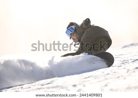 Image of a woman snowboarding
