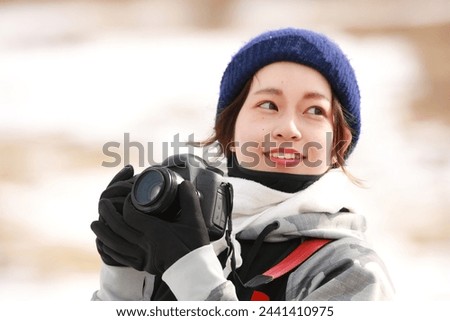 Image of a woman taking a photo
