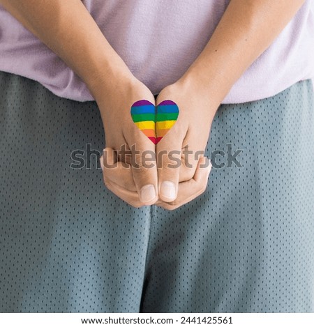 Rainbow heart drawing on hands. Holding hands, symbol of love, LGBT