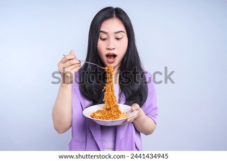 Young Asian woman enjoying eating fried noodles on plate