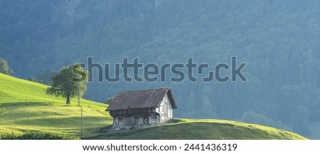 Alps old wooden house. Old House in the European Alps. Old Cabin in the forest. Dilapidated house in the European Alps. Old village houses in a small town in an Alp valley. Royalty-Free Stock Photo #2441436319