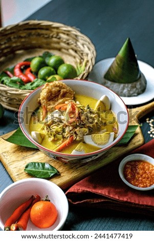 Indonesian soup dish featuring rich broth, tender chicken, vermicelli, and aromatic spices like lemongrass and lime leaves, originating from Medan city.