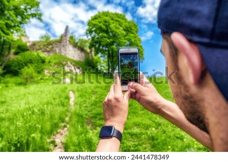 Visitor making picture with smartphone of castle Zniev, Slovakia