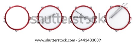 Bright toy drums and sticks on white background, top view