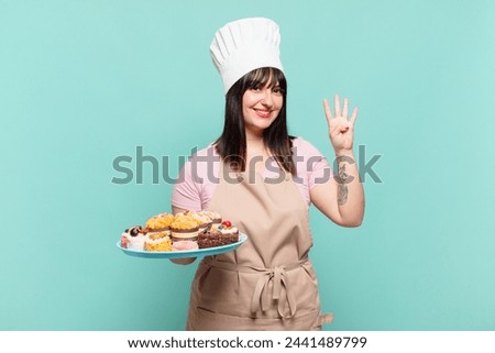 young chef woman smiling and looking friendly, showing number four or fourth with hand forward, counting down