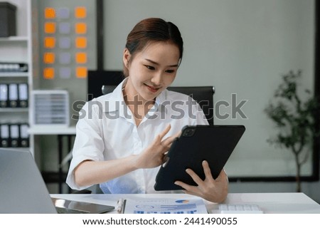 Business woman working at office with laptop and documents on desk, financial adviser analyzing data.
