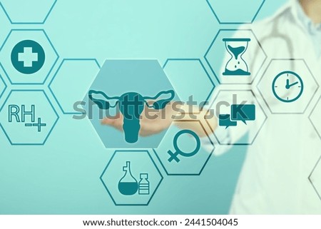 Menopause concept. Doctor touching uterus icon on digital screen against turquoise background, closeup