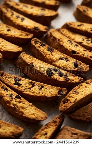 Biscotti on the baking pan. Traditional Sweet Italian cookies that are making with two times baking, with nuts and dried cranberries. Extra crunchy and dry. High quality photo Royalty-Free Stock Photo #2441504239