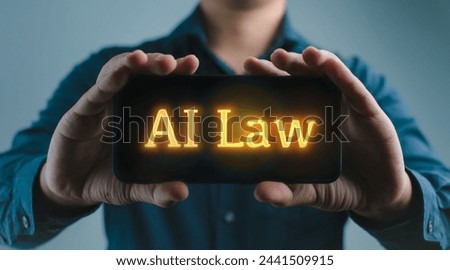 A man is holding a smart phone with the word AI law ,AI Regulation, AI Legislation Concept of artificial intelligence and its legal implications