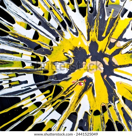 A captivating abstract artwork showcasing a dynamic explosion of yellow and black paint, creating an energetic and vibrant visual experience. Royalty-Free Stock Photo #2441525049