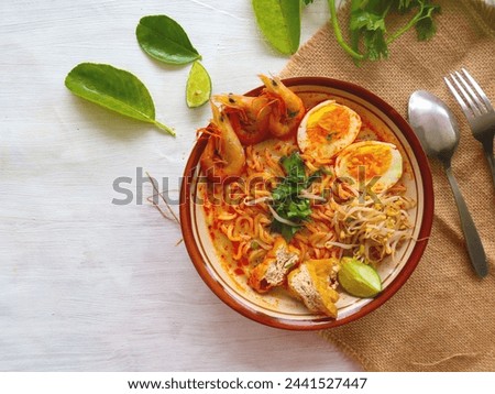 a picture of a plate of food containing prawns , spaghetti and boiled eggs