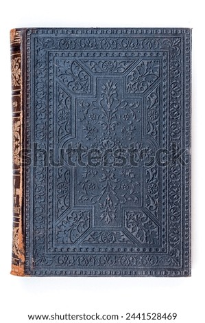 An antique book boasts an intricately embossed cover, showcasing detailed patterns and designs, exuding a sense of classic elegance and the rich history of literature.