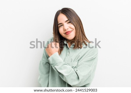 pretty hispanic woman feeling happy, positive and successful, motivated when facing a challenge or celebrating good results