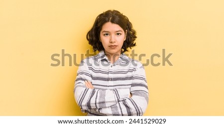 pretty hispanic woman feeling displeased and disappointed, looking serious, annoyed and angry with crossed arms