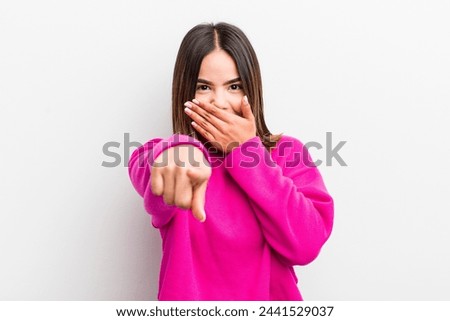 pretty hispanic woman laughing at you, pointing to camera and making fun of or mocking you