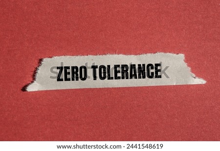 Zero tolerance words written on torn paper piece with red background. Conceptual photo. Copy space.