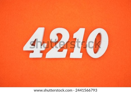 Orange felt is the background. The numbers 4210 are made from white painted wood.