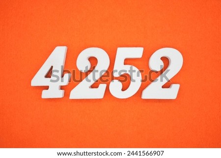 Orange felt is the background. The numbers 4252 are made from white painted wood.