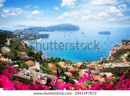 lanscape of riviera coast, turquiose water, flowers and blue sky of cote dAzur at summer day, France, retro toned Royalty-Free Stock Photo #2441597873