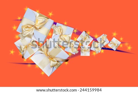 White boxes with gold ribbon on orange