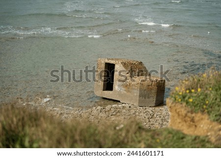 
blockhouse on the edge of the Atlantic Ocean. On the beach Royalty-Free Stock Photo #2441601171