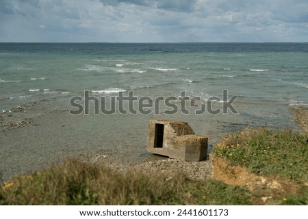 
blockhouse on the edge of the Atlantic Ocean. On the beach Royalty-Free Stock Photo #2441601173
