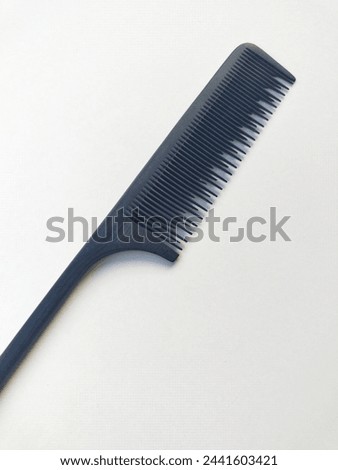 Black sasak comb on a white background.