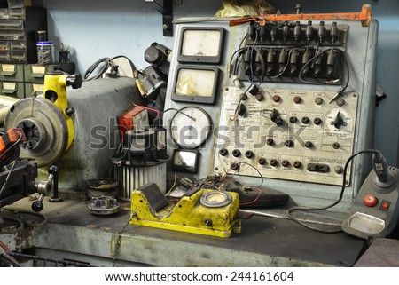 Old electro-mechanic tool in a workshop Royalty-Free Stock Photo #244161604