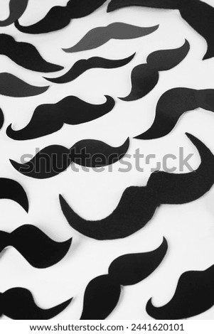 Fake paper mustaches on white background, flat lay
