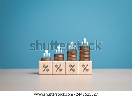 Growth sign on coins with percentage wooden cubes, financial banking interest rate hikes and business investment profit dividends, the raising of interest rates, inflation, and returns on investments.