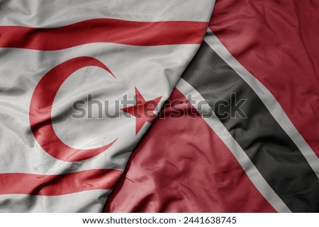 big waving national colorful flag of trinidad and tobago and national flag of northern cyprus. macro