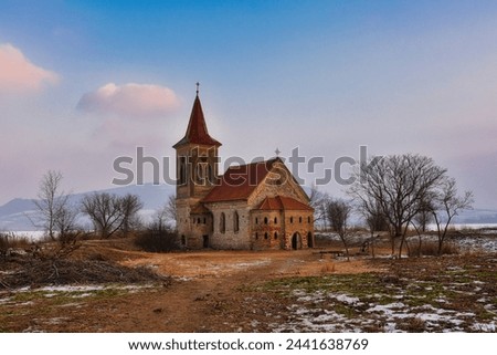 Beautiful old church of St. Linhart. Catholic temple village of Musov - Pasohlavky, Czech Republic. Photo of winter landscape with sunset on a dam New Mills (Nove Mlyny).